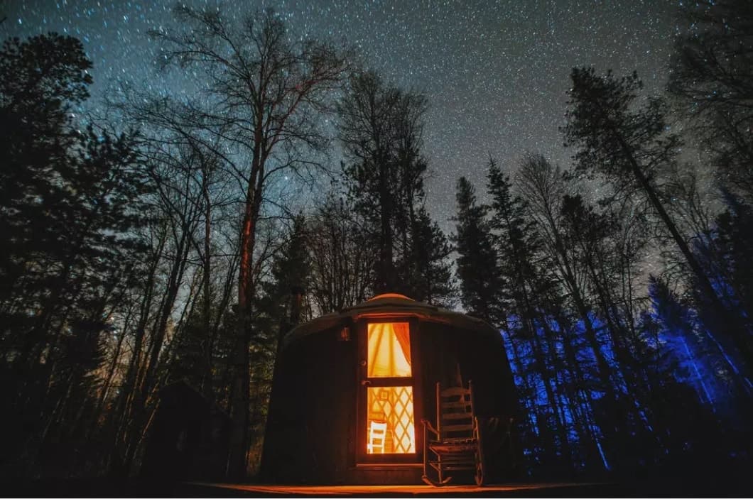 Front view of a small yurt at night